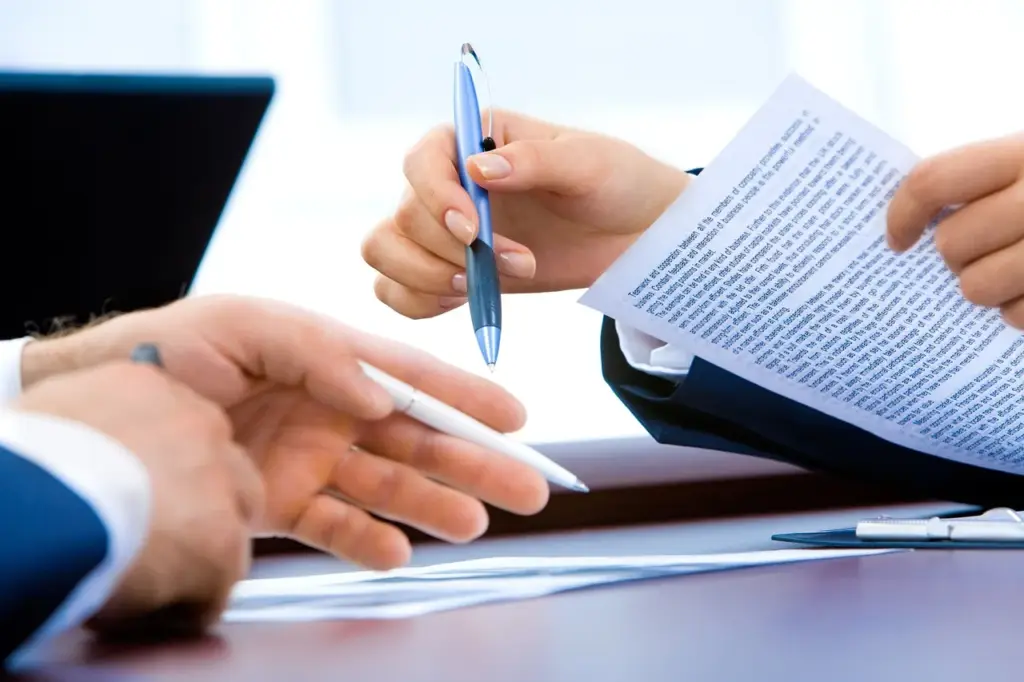 Person reviewing insurance claim paperwork at a desk