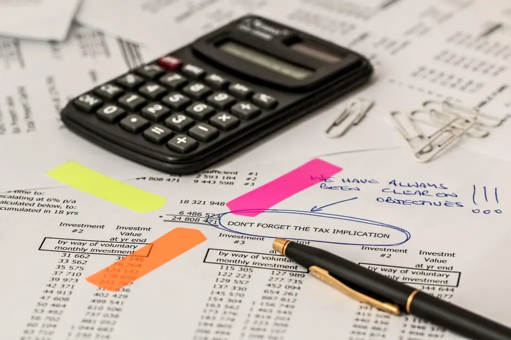 People reviewing insurance documents and claim forms at home