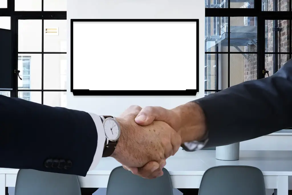 Handshake during an insurance settlement negotiation