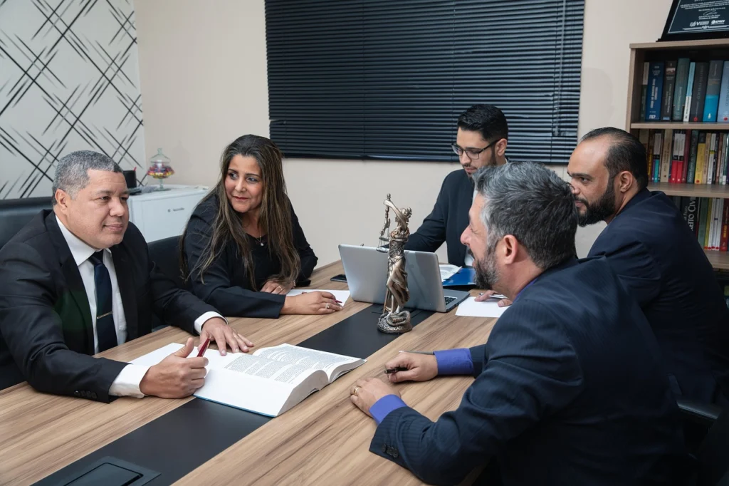 Lawyer reviewing a car accident claim with a client, discussing pain and suffering damages