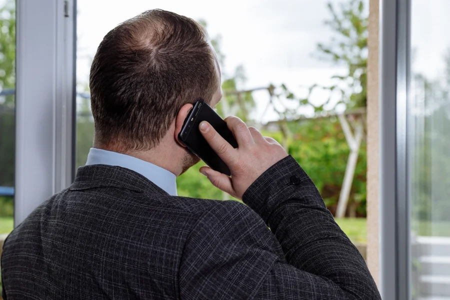 A person on the phone negotiating with an insurance adjuster