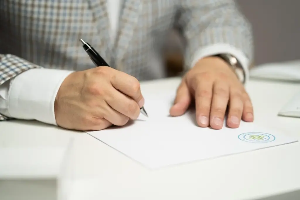 Man signing workers comp appeal papers